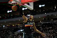| Photo: AP/Aaron Gash : San Antonio Spurs' Victor Wembanyama dunks during the second half of an NBA basketball game against the Milwaukee Bucks in Milwaukee.