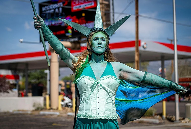 Carrie Chavez, dressed as the Statue of Liberty, participates in a "No Kings" march on Montgomery Blvd in Albuquerque, New Mexico. - | Photo: Jessica Baca/The Albuquerque Journal via AP