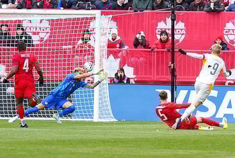 Iceland's Orri Steinn Oskarsson (9) scores a goal past Canada goalkeeper Dayne St. Clair  during an international friendly soccer match in Toronto.