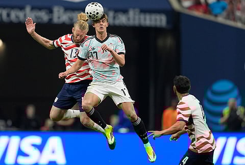 United States' Tim Ream (13) and Belgium's Charles De Ketelaere (17) battle for a header during the second half of an international friendly soccer match, in Atlanta.