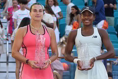 Aryna Sabalenka, left, and Coco Gauff pose with their trophies after the women's singles final at the Miami Open tennis tournament in Miami Gardens, Florida.