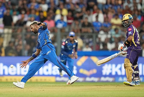 Mumbai Indians' captain Hardik Pandya, left, fields the ball during the Indian Premier League cricket match between Mumbai Indians and Kolkata Knight Riders in Mumbai.