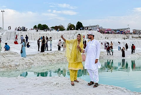 People pose for photographs at the marble waste dumping yard, in Kishangarh, Rajasthan.