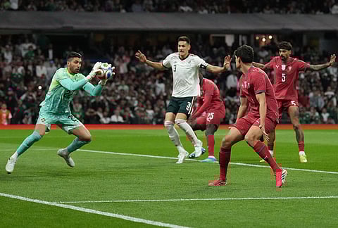 Portugal's goalkeeper Rui Silva, left, catches the ball during the international friendly soccer match between Mexico and Portugal in Mexico City.