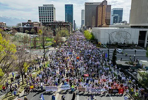 People walk from Washington Square Park to the Capitol during a "No Kings" anti-Trump protest in Salt Lake City.