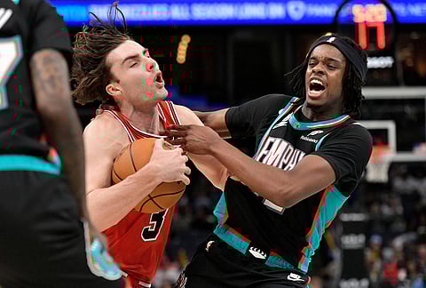 Chicago Bulls guard Josh Giddey (3) drives against Memphis Grizzlies forward Adama Bal, right, in the first half of an NBA basketball game in Memphis, Tennessee.