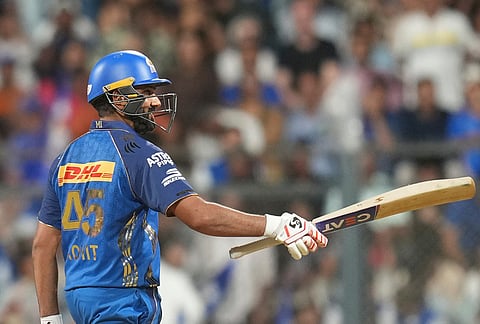 Mumbai Indians' Rohit Sharma celebrates his fifty runs during the Indian Premier League cricket match between Mumbai Indians and Kolkata Knight Riders in Mumbai.