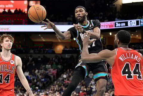 Memphis Grizzlies guard DeJon Jarreau (77) passes the ball between Chicago Bulls forwards Patrick Williams (44) and Matas Buzelis (14) in the second half of an NBA basketball game in Memphis, Tennesee.