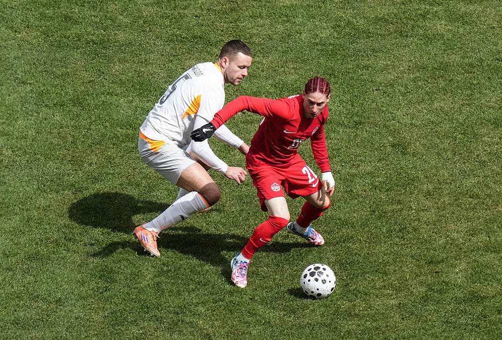 Canada's Marcelo Flores turns away from Iceland's Sverrir Ingi Ingason during the second half of an international friendly soccer match in Toronto. - | Photo: Chris Young/The Canadian Press via AP