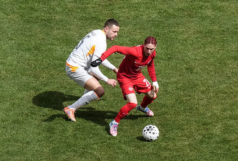 Canada's Marcelo Flores turns away from Iceland's Sverrir Ingi Ingason during the second half of an international friendly soccer match in Toronto. - | Photo: Chris Young/The Canadian Press via AP