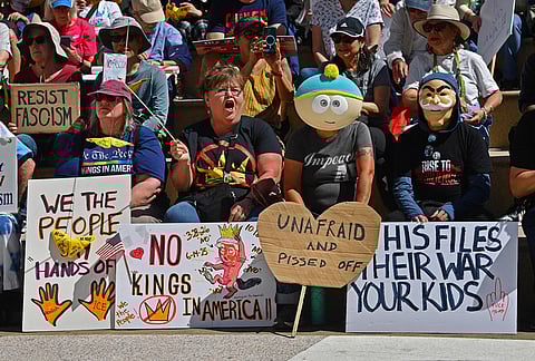 Demonstrators gather before the start of the "No Kings" protest in Oakland, California.