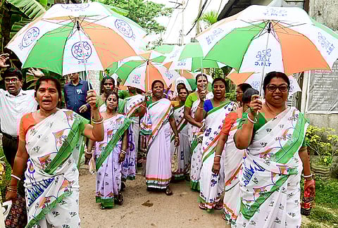 TMC workers take part in a rally in favour of party candidate Subhasish Chakraborty for Behala Purba Assembly constituency during his election campaign at Kabardanga, in Kolkata.