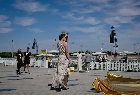 A racegoer arrives at the Meydan Racecourse ahead of the Dubai World Cup, United Arab Emirates.