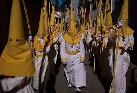 Penitents of the "Pollinita" brotherhodod take part in a Holy Week procession in Cabra, southern Spain.