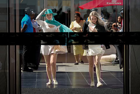 Racegoers arrive at the grandstand ahead of the Dubai World Cup at Meydan Racecourse in Dubai, United Arab Emirates.