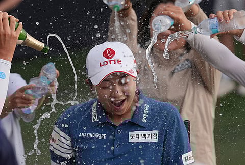 Hyo Joo Kim, of South Korea, gets doused with champagne and water at the 18th green after winning the LPGA Ford Championship golf tournament in Chandler, Arizona.
