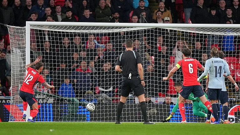 England's Ben White, left, scores his side's opening goal during the international friendly soccer match between England and Uruguay in London. - Photo: AP/Alastair Grant