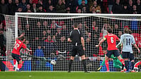 Photo: AP/Alastair Grant : England's Ben White, left, scores his side's opening goal during the international friendly soccer match between England and Uruguay in London.