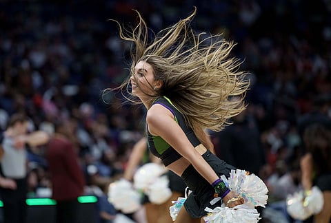 A member of the New Orleans Pelicans PelSquad performs during an NBA basketball game against the Houston Rockets in New Orleans.