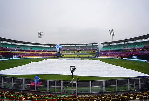 Ground staff bring covers on the field during rain, ahead of an Indian Premier League (IPL) 2026 T20 cricket match between Rajasthan Royals and Chennai Super Kings, at ACA Stadium, Barsapara, in Guwahati, Assam.