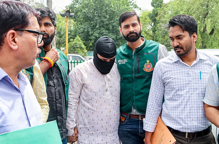 Delhi Police Special Cell personnel produce Shabir Ahmad Lone, an accused linked to Lashkar-e-Taiba (LeT) and alleged to be part of a module involved in defacing Delhi Metro station walls and planning further activities, at Patiala House Court, in New Delhi, Monday, March 30, 2026. - PTI