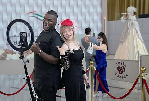 Racegoers pose for photos in the grandstand ahead of the Dubai World Cup at Meydan Racecourse in Dubai, United Arab Emirates.