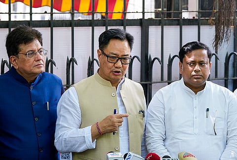 Union Ministers Kiren Rijiju, center, Piyush Goyal, left, and Minister of State for Education Sukanta Majumdar, address the media at the Election Commission of India headquarters, in New Delhi.