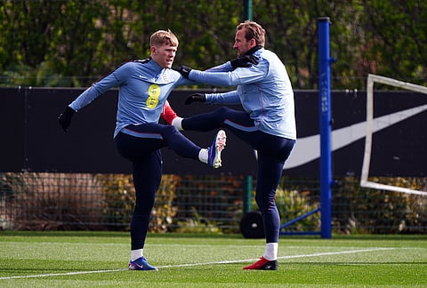 England's Lewis Hall and Harry Kane, right, exercise during a training session in London.