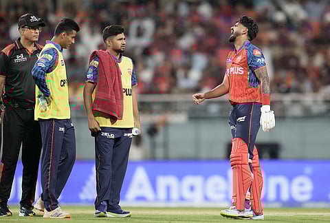 Punjab Kings' captain Shreyas Iyer, right, winces in pain after getting hit by a shot from batting partner Cooper Connolly during the Indian Premier League cricket match between Gujarat Titans and Punjab Kings in New Chandigarh.