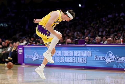 Los Angeles Lakers guard Austin Reaves reacts during the second half of an NBA basketball game against the Washington Wizards in Los Angeles. 