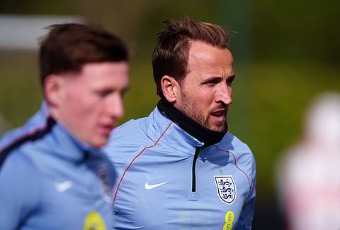 England's Harry Kane, right, exercises during a training session in London.