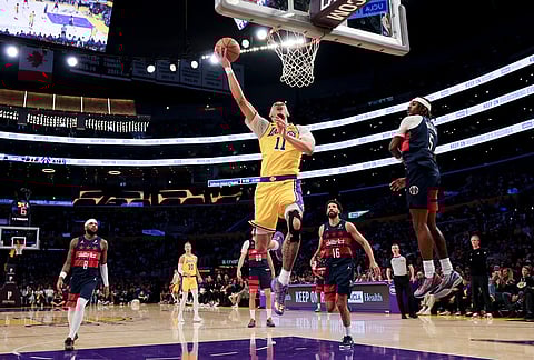 Los Angeles Lakers center Jaxson Hayes (11) shoots against Washington Wizards guard Jamir Watkins (5) during the second half of an NBA basketball game in Los Angeles.