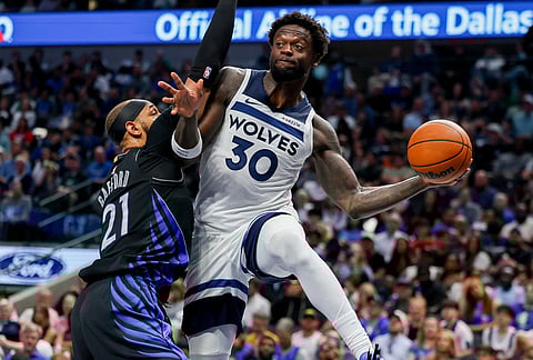 Minnesota Timberwolves forward Julius Randle (30) looks to pass the ball around Dallas Mavericks forward Daniel Gafford (21) in the second half of an NBA basketball game in Dallas. 