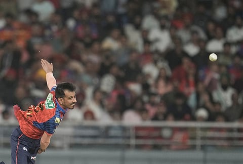 Punjab Kings' Yuzvendra Chahal bowls a delivery during the Indian Premier League cricket match between Gujarat Titans and Punjab Kings in New Chandigarh.