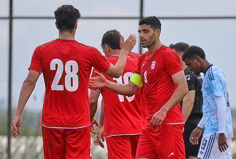 Iran's Mehdi Taremi, right, celebrates with teammates after scoring their side's fourth goal during a friendly soccer match between Iran and Costa Rica, in Antalya, southern Turkey.