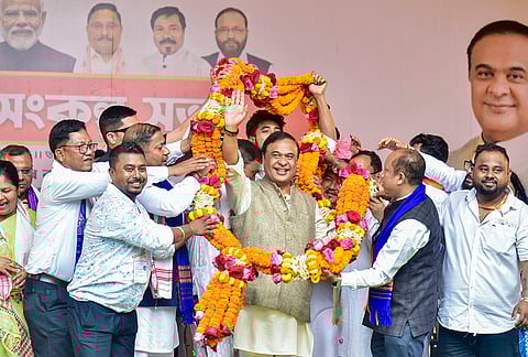 Assam Chief Minister Himanta Biswa Sarma being garlanded by supporters during a public rally in support of NDA candidate for Dimoria constituency Tapan Das, unseen, ahead of the Assam Assembly Election, in Kamrup Metropolitan district.