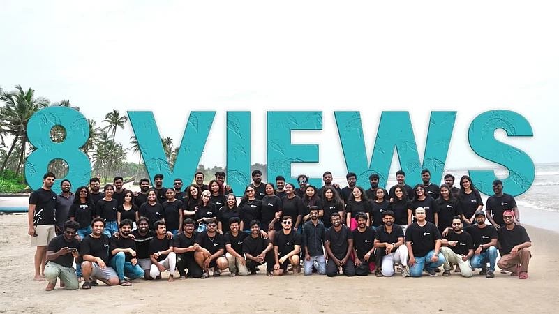 Large group on a beach behind 8 VIEWS text