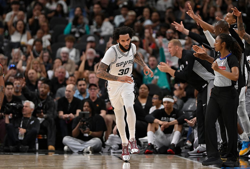 San Antonio Spurs forward Julian Champagnie (30) celebrates after a 3-point basket during the second half of an NBA basketball game against the Chicago Bulls in San Antonio.  - | Photo: AP/Darren Abate