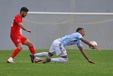 Iran's Shahriar Moghanlou, left, vies for the ball with Costa Rica's Jorkaeff Azofeifa during a friendly soccer match between Iran and Costa Rica, in Antalya, southern Turkey.