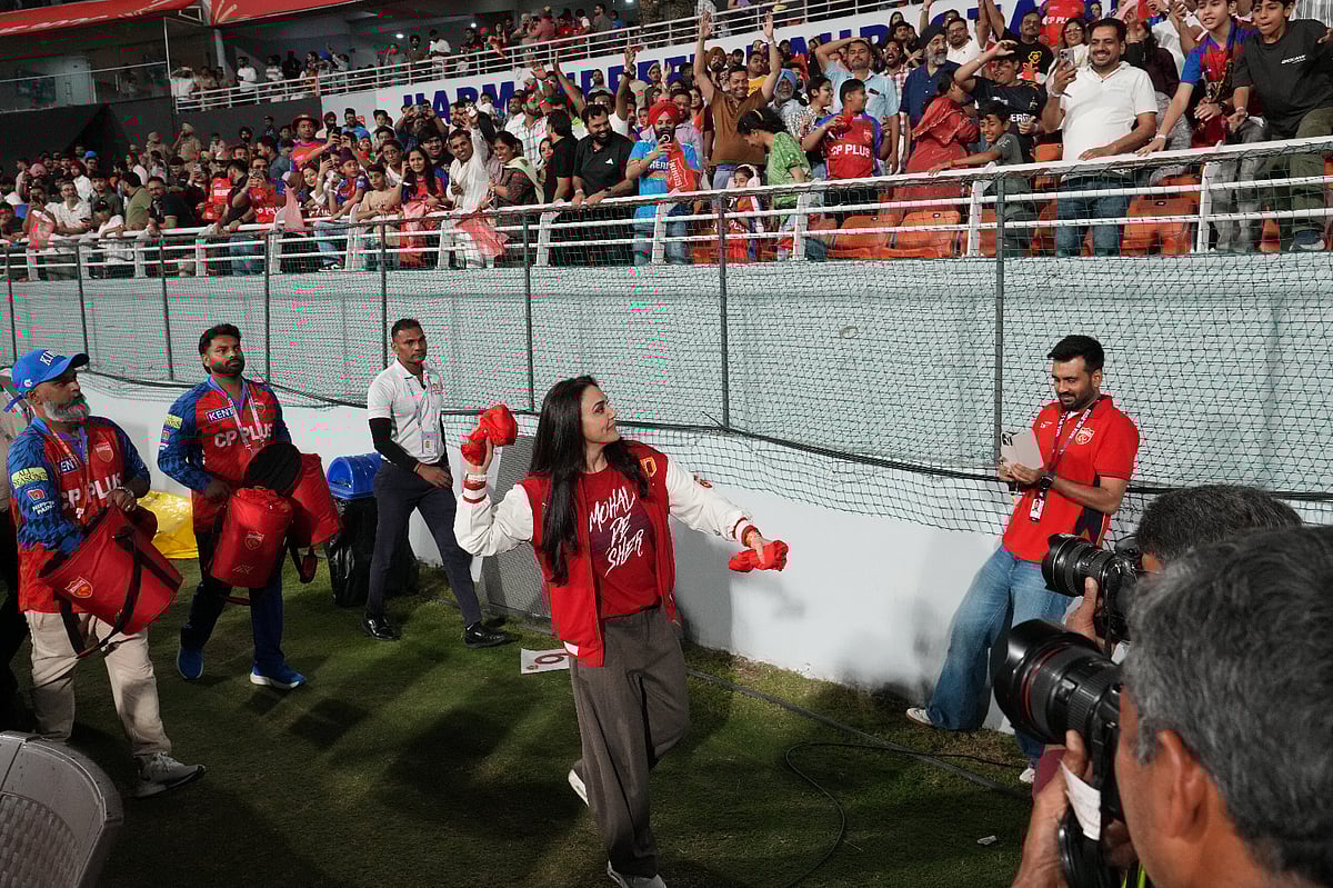 Punjab Kings' co-owner Preity Zinta throw jersey to the stands during the Indian Premier League cricket match between Gujarat Titans and Punjab Kings in New Chandigarh, India, Tuesday, March 31, 2026.