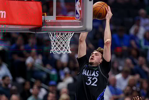 Dallas Mavericks forward Cooper Flagg dunks in the first half of an NBA basketball game against the Minnesota Timberwolves in Dallas. 