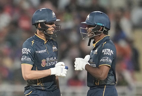 Gujarat Titans' captain Shubman Gill and Sai Sudharsan touch the glows as they bats during the Indian Premier League cricket match between Gujarat Titans and Punjab Kings in New Chandigarh.