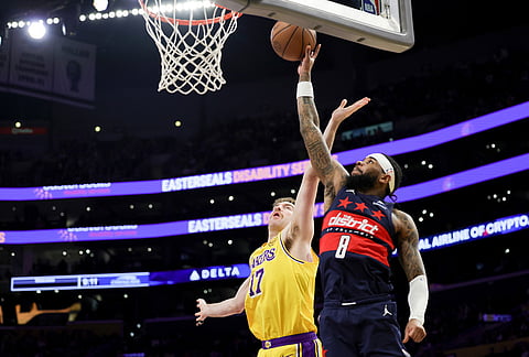 Los Angeles Lakers forward Drew Timme, left, defends Washington Wizards guard Jaden Hardy during the second half of an NBA basketball game in Los Angeles. 