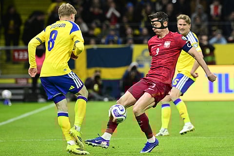 Sweden's Daniel Svensson, left, against Poland's Robert Lewandowski during a World Cup qualifying playoff final soccer match.
