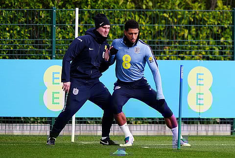 England's Jude Bellingham, right, exercises during a training session in London.