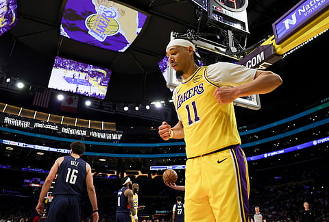 Los Angeles Lakers center Jaxson Hayes celebrates after drawing an and-one foul during the second half of an NBA basketball game against the Washington Wizards in Los Angeles.
