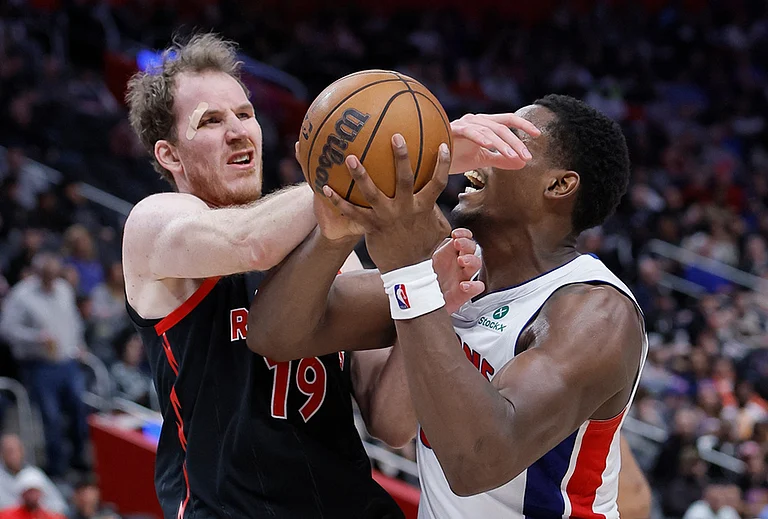 Detroit Pistons center Jalen Duren (0) is fouled by Toronto Raptors center Jakob Poeltl (19) while going to the basket during the second half of an NBA basketball game in Detroit. - | Photo: AP/Duane Burleson