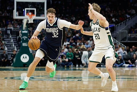 Dallas Mavericks forward Cooper Flagg (32) drives against Milwaukee Bucks guard AJ Green (20) during the second half of an NBA basketball game in Milwaukee.