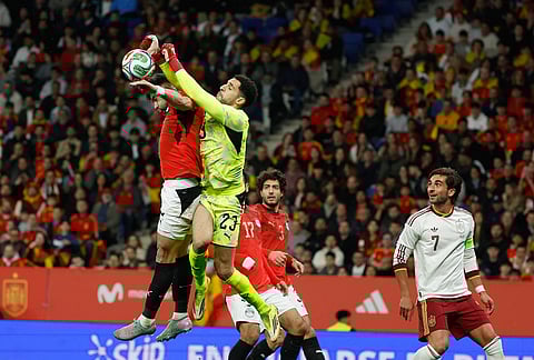 Egypt's goalkeeper Mostafa Shobeir, right, saves with his teammate Yasser Ibrahim during the international friendly soccer match between Spain and Egypt in Barcelona, Spain.
