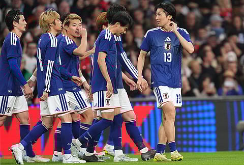 Japan players celebrate scoring their side's first goal during the International friendly soccer match between England and Japan in London.